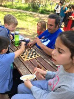 Students and a faculty member play chess at Kanaf Sudbury School in Eliad, Israel